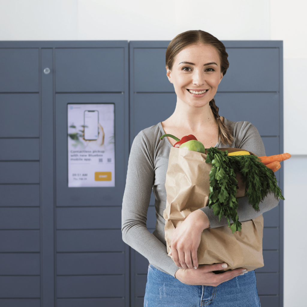 Woman picking up food from BlueBox food locker